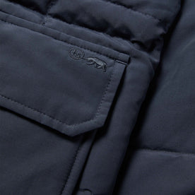 material shot of the embroidered pocket of The Whitney Parka in Navy