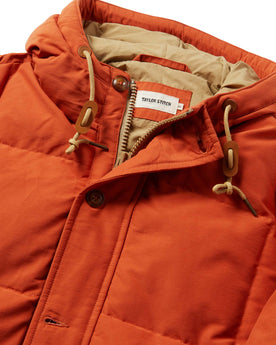material shot of The Whitney Parka in Dusty Orange showing the interior label, Outerwear by Taylor Stitch