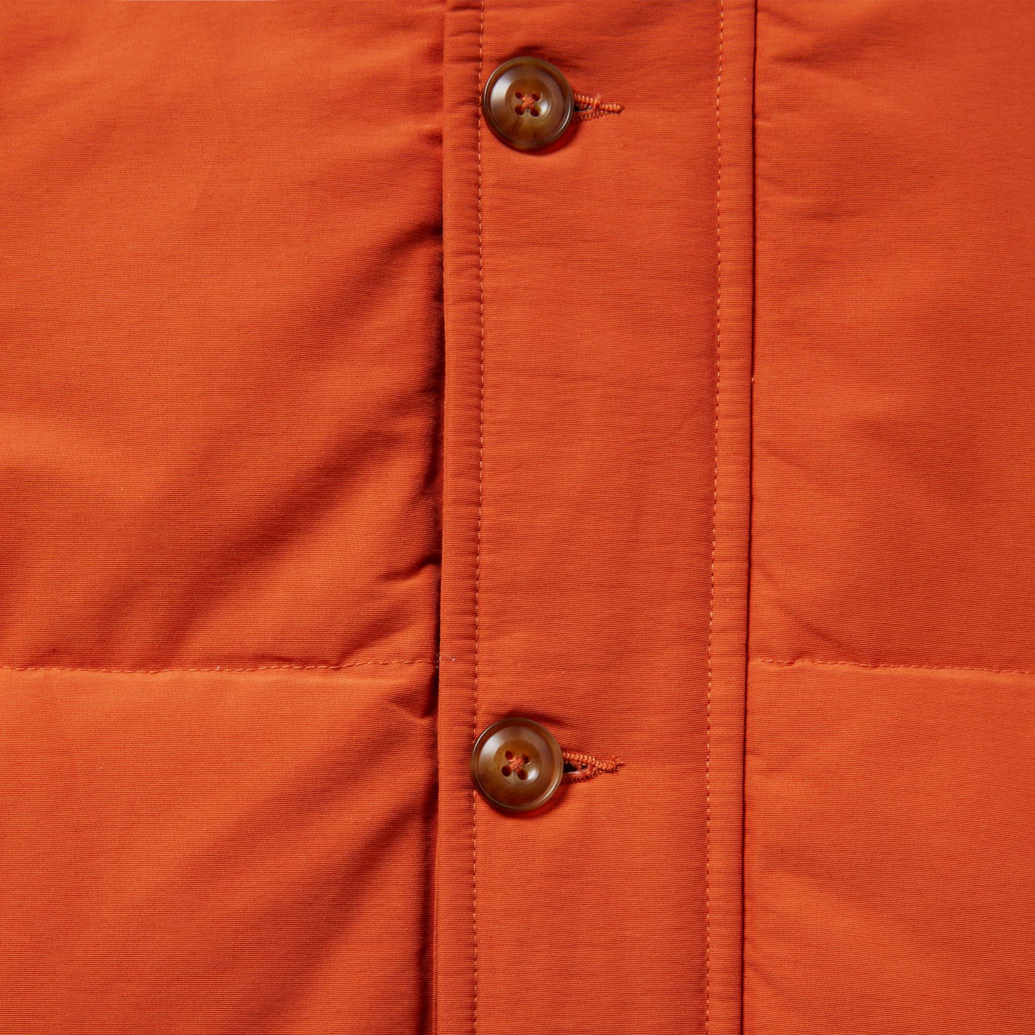 material shot of the placket and front buttons of The Whitney Parka in Dusty Orange, Outerwear by Taylor Stitch