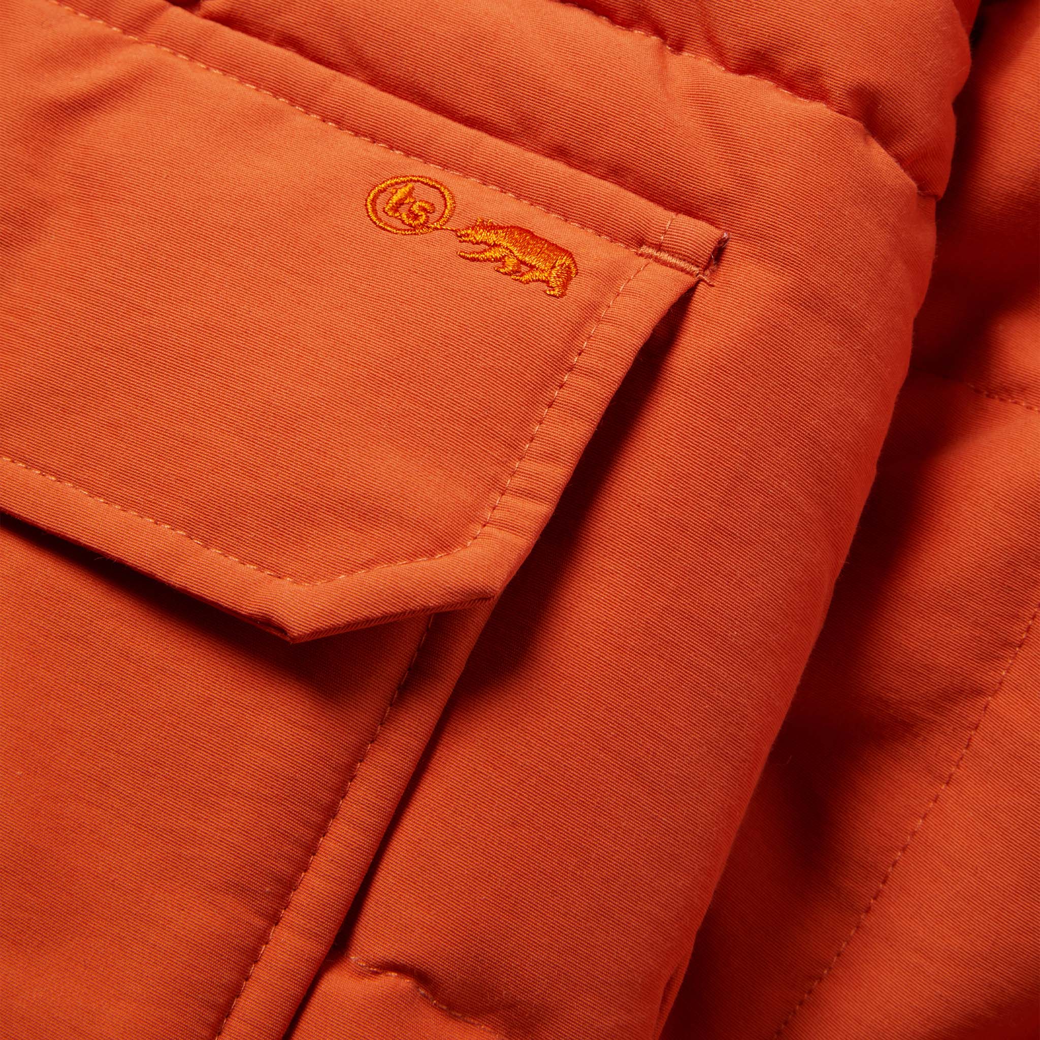 material shot of the front pocket of The Whitney Parka in Dusty Orange, Outerwear by Taylor Stitch