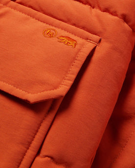 material shot of the front pocket of The Whitney Parka in Dusty Orange, Outerwear by Taylor Stitch