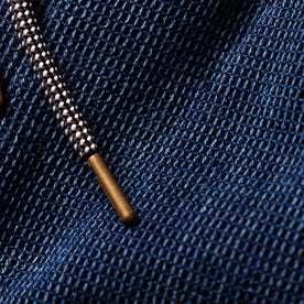 material shot of the metal tipped drawcord on The Apres Pant in Indigo Waffle