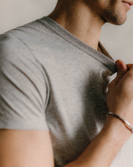fit model showing off logo detail on The Cotton Hemp Tee in Heather Grey, Knits by Taylor Stitch