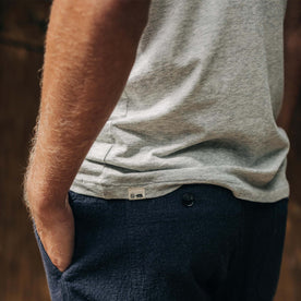 fit model showing off logo detail on The Cotton Hemp Tee in Heather Grey