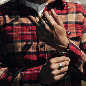 fit model adjusting the cuffs on The Crater Shirt in Cardinal Check