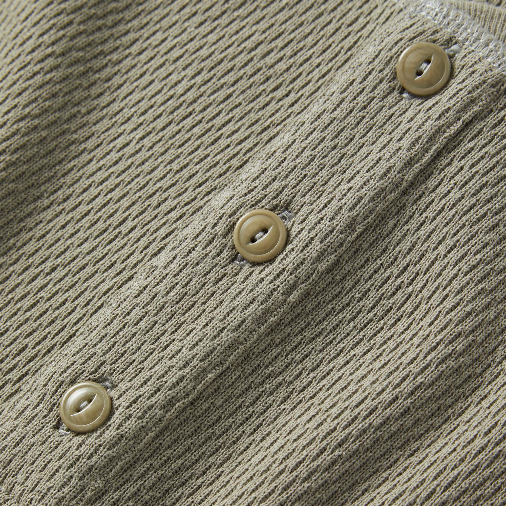 material shot of the buttons on The Heavy Bag Waffle Henley in Army, Knits by Taylor Stitch