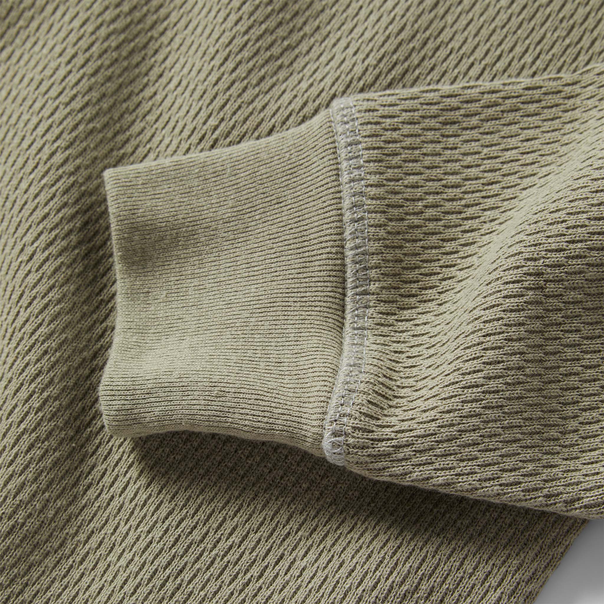 material shot of the sleeves on The Heavy Bag Waffle Henley in Army, Knits by Taylor Stitch