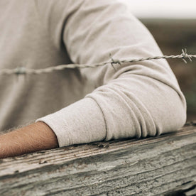 fit model showing the cuffs on The Heavy Bag Henley in Oatmeal