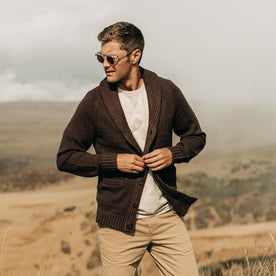 fit model buttoning up The Headland Shawl Cardigan in Marled Chocolate