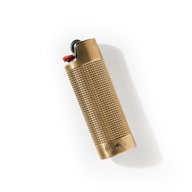editorial image of The Lighter Sleeve in Brass flatlay