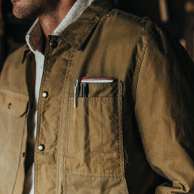 fit model showing off the pockets of The Lined Longshore Jacket in Harvest Tan Waxed Canvas