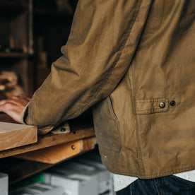 fit model showing pockets and hem on The Lined Longshore Jacket in Harvest Tan Waxed Canvas