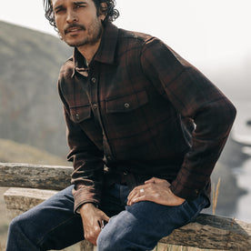 fit model sitting on a fence in The Maritime Shirt Jacket in Carson Plaid
