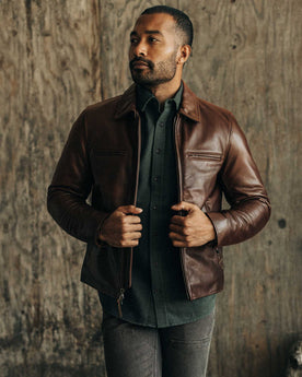 fit model sitting on a motorcycle in The Moto Jacket in Espresso Steerhide, Outerwear by Taylor Stitch