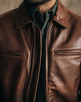 fit model sitting in The Moto Jacket in Espresso Steerhide, Outerwear by Taylor Stitch