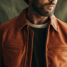 fit model with his collar popped wearing The Moto Jacket in Whiskey Steerhide