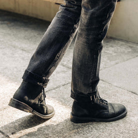 fit model walking in The Moto Boot in Black Weatherproof Nubuck