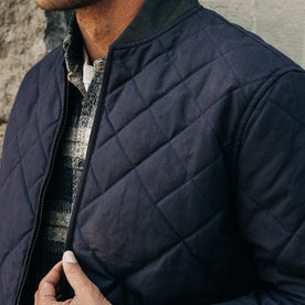 fit model showing off detail on The Quilted Bomber Jacket in Navy Dry Wax
