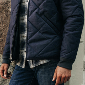 fit model showing off hem on The Quilted Bomber Jacket in Navy Dry Wax