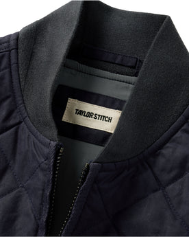 material shot of the collar on The Quilted Bomber Vest in Navy Dry Wax, Outerwear by Taylor Stitch