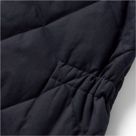material shot of the cinched detail on The Quilted Bomber Vest in Navy Dry Wax