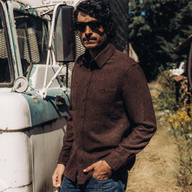 fit model posing by a truck wearing The Service Shirt in Ginger Melange Wool