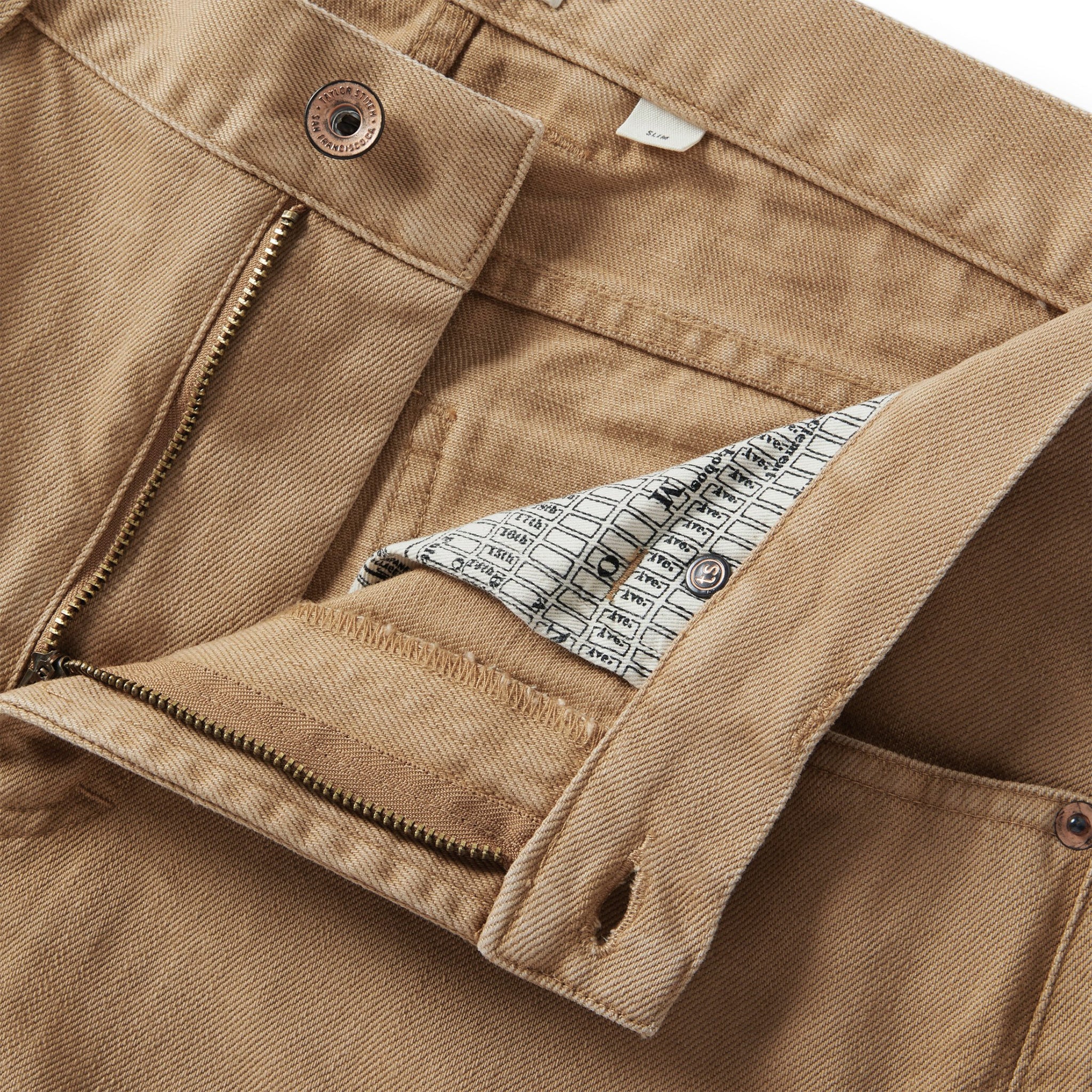 material shot of the fly on The Slim All Day Pant in Washed Tobacco Selvage, Bottoms by Taylor Stitch