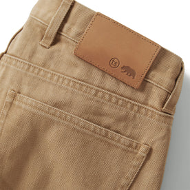 material shot of the back leather flap on The Slim All Day Pant in Washed Tobacco Selvage