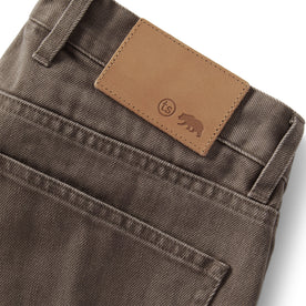 material shot of the leather detail on The Slim All Day Pant in Washed Walnut Selvage