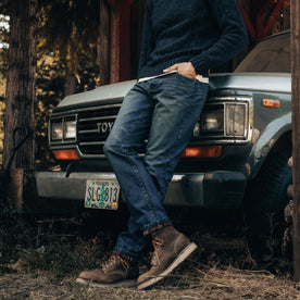fit model leaning against a car wearing The Slim Brushed Back Jean in Sawyer Wash Organic Selvage