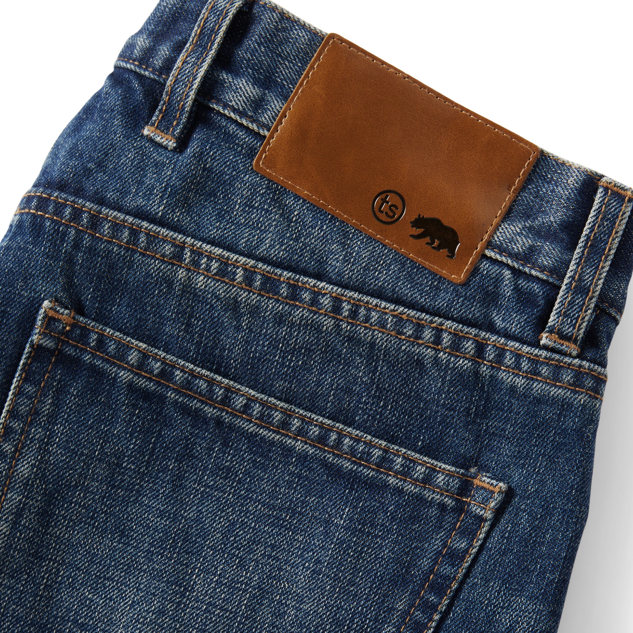 material shot of the leather logo panel on The Slim Brushed Back Jean in Sawyer Wash Organic Selvage, Bottoms by Taylor Stitch