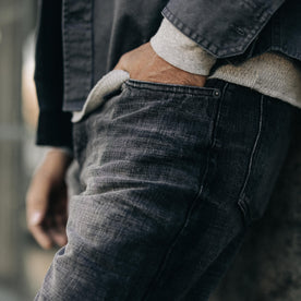 fit model with his hand in the pocket of The Slim Jean in Black 3-Month Wash Selvage