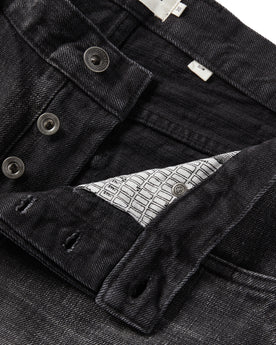 material shot of the button fly on The Slim Jean in Black 3-Month Wash Selvage, Bottoms by Taylor Stitch