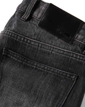 material shot of the leather logo patch on The Slim Jean in Black 3-Month Wash Selvage, Bottoms by Taylor Stitch