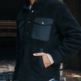 fit model with his hand in the pocket of The Timberline Jacket in Onyx Sherpa