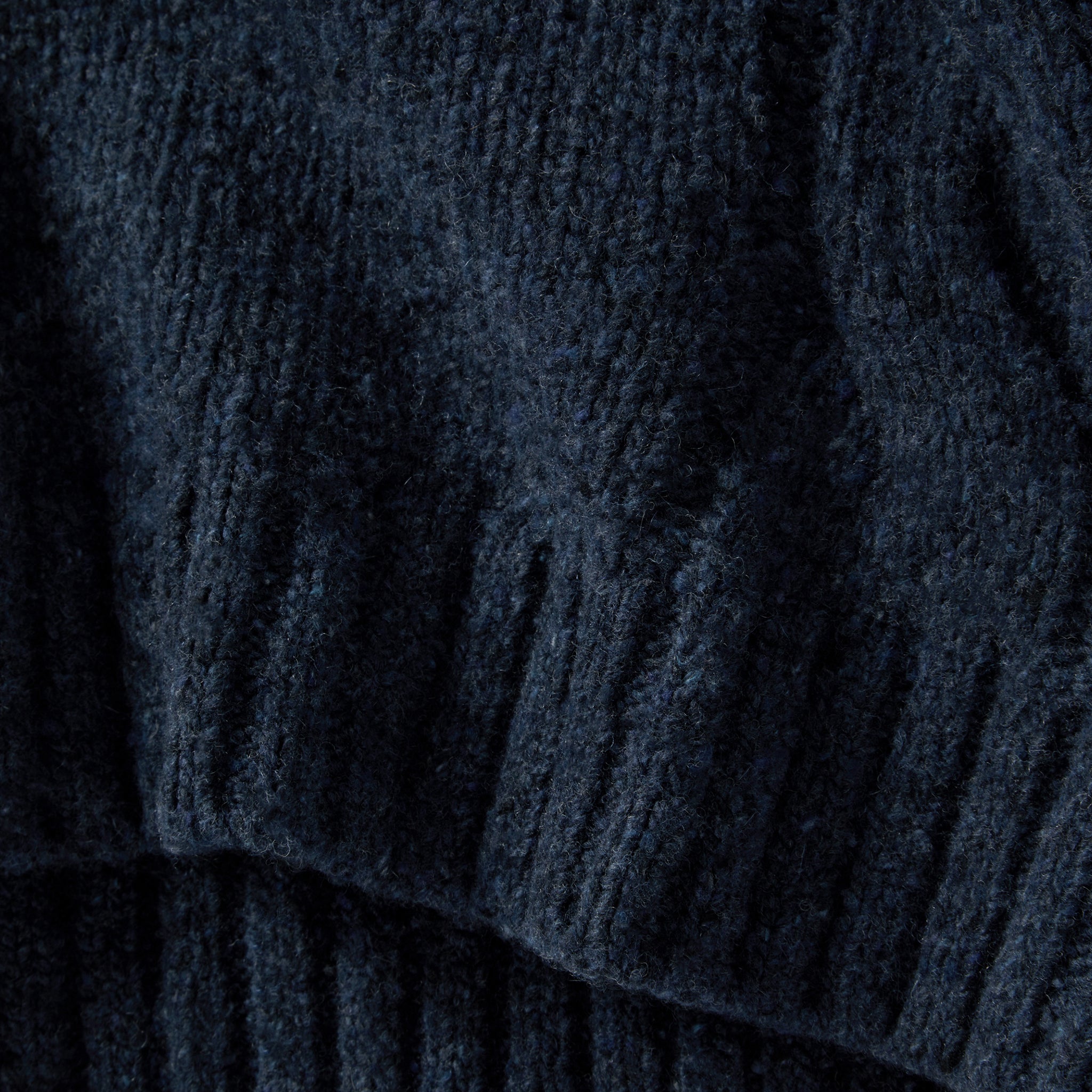 material shot of the hem on The Topside Sweater in Navy Donegal, Knits by Taylor Stitch