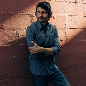fit model leaning against the wall in The Utility Shirt in Navy Jaspe