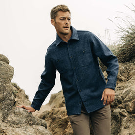 fit model on rocks wearing The Utility Shirt in Navy Donegal Wool