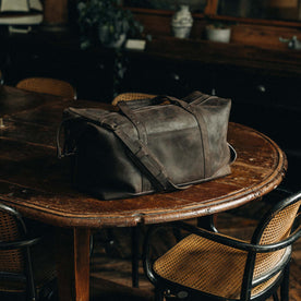 material shot of The Weekender Duffle Bag in Espresso on a wooden table