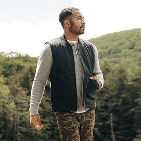fit model with his hand in his pocket of The Workhorse Vest in Coal Boss Duck