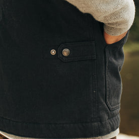 fit model showing off back clasp on The Workhorse Vest in Coal Boss Duck