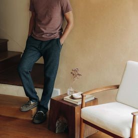 fit model leaning against the wall wearing The Weekend Pant in Charcoal Herringbone Wool 