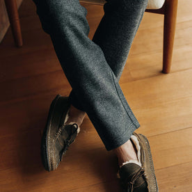 fit model crossing his legs wearing The Weekend Pant in Charcoal Herringbone Wool 