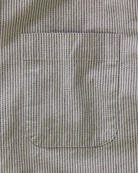 material shot of the button on the back collar of The Jack in Coal Jaspe University Stripe Oxford, Wovens by Taylor Stitch