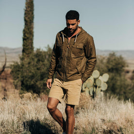 our fit model wearing The Welterweight Winslow in Field Tan Waxed Canvas out in the desert—walking shot