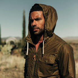 our fit model wearing The Welterweight Winslow in Field Tan Waxed Canvas out in the desert—cropped shot of chest up
