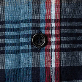 Close up material shot of button and perpendicular plaid