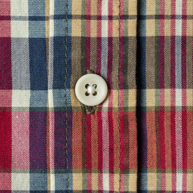 Close up material shot with perpendicular plaid and close up of button