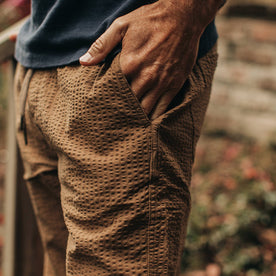 our fit model wearing The Après Pant in British Khaki Seersucker—cropped shot, hand in pocket