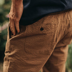 our fit model wearing The Après Pant in British Khaki Seersucker—cropped shot of pant back